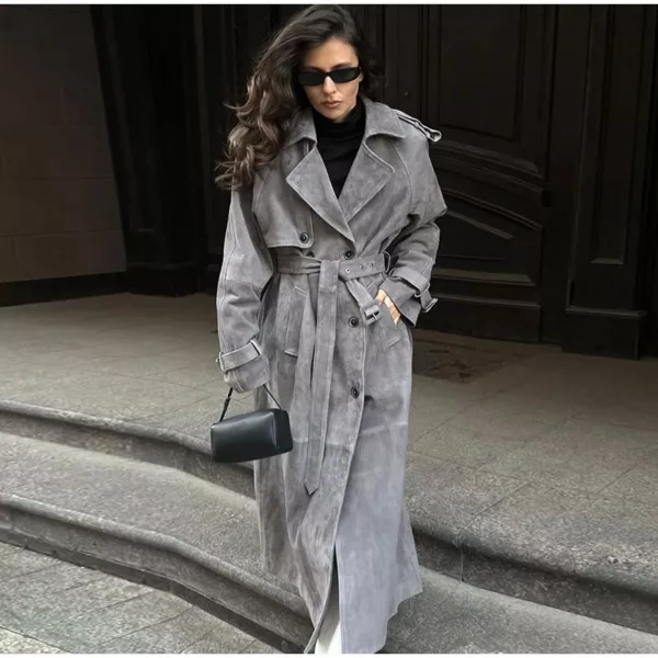 Model wearing a full-length suede trench coat in brown.