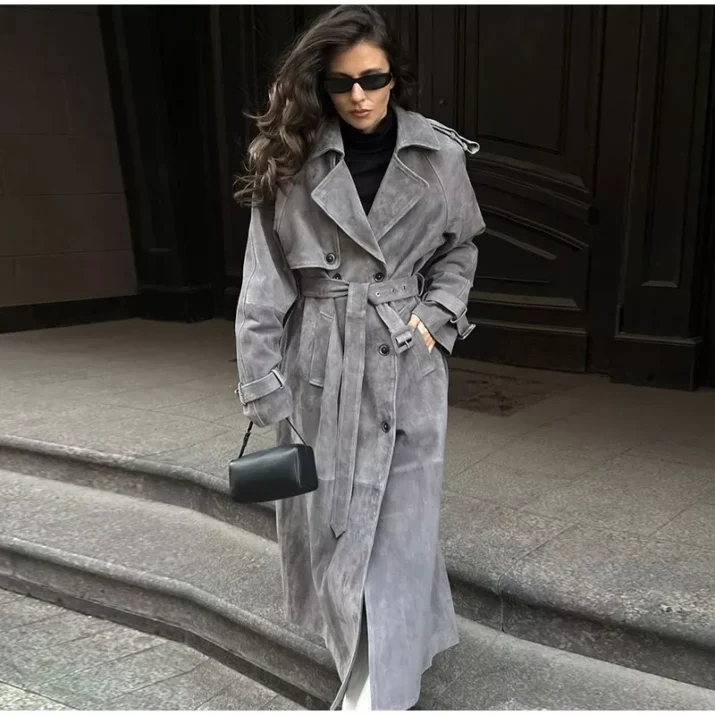 Model wearing a full-length suede trench coat in brown.