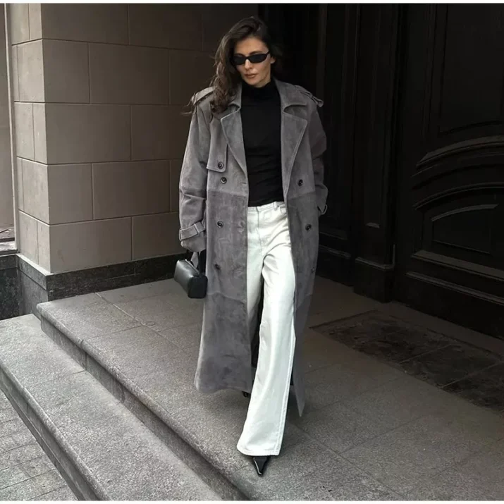 Model wearing a full-length suede trench coat in brown.
