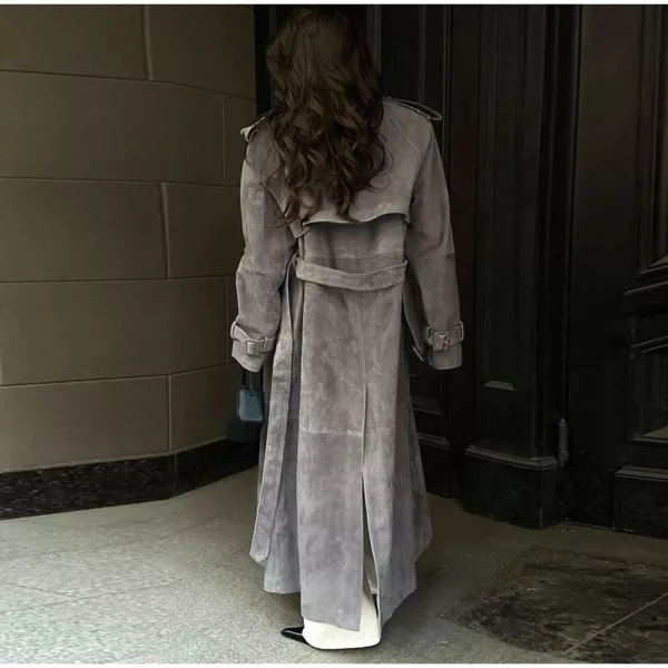 Model wearing a full-length suede trench coat in brown.