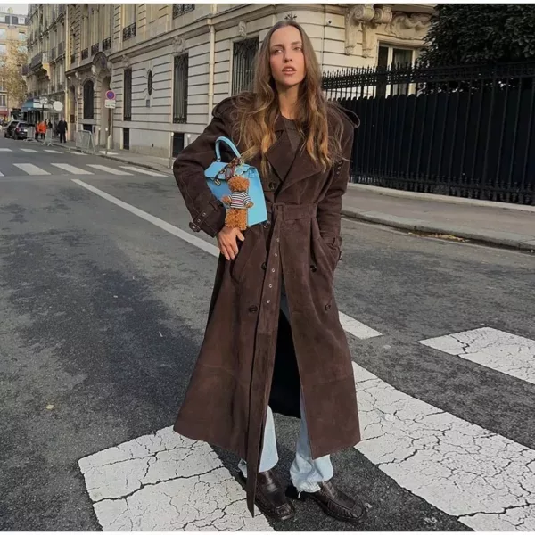 Model wearing a full-length suede trench coat in brown.