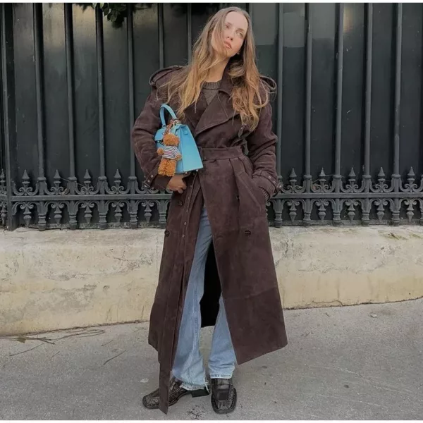 Model wearing a full-length suede trench coat in brown.